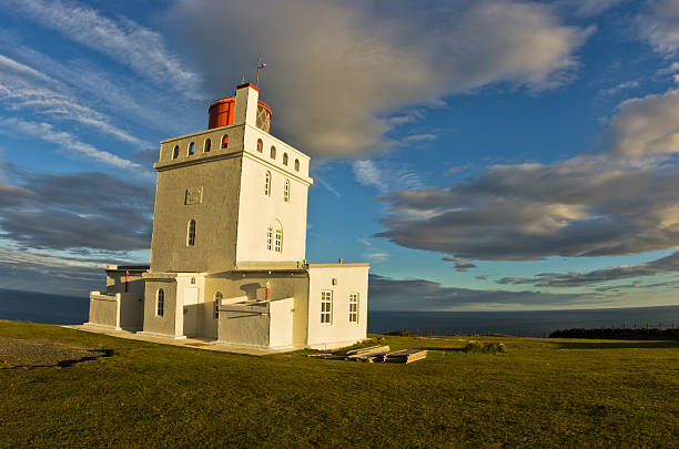 istock Lighthouse at Dyrholaey rock at sunset with dramatic sky 498995578