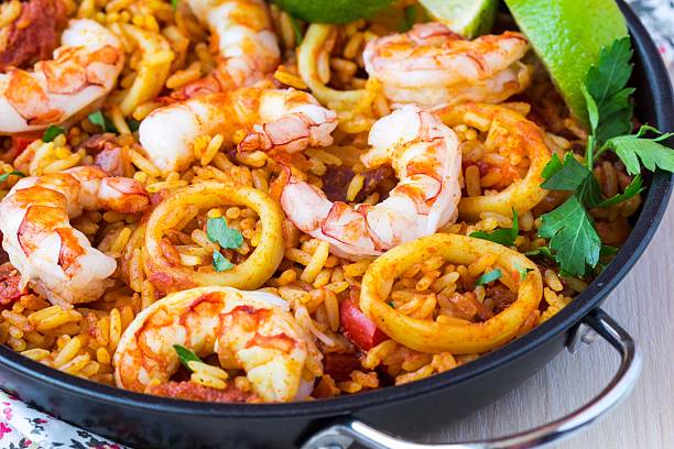 Spanish dish paella with seafood, shrimps, squid, rice, saffron stock photo