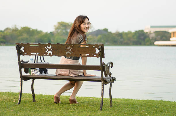 istock woman sitting on bench 498997147