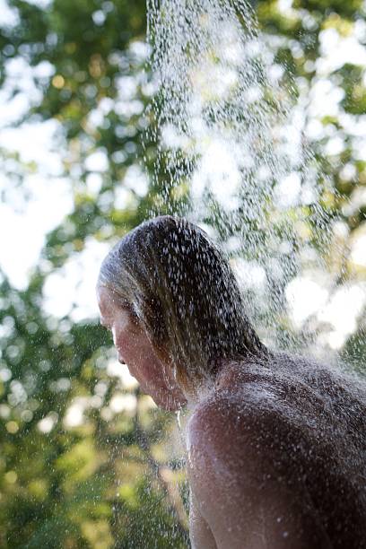 istock Blonde male showering outside 498997376