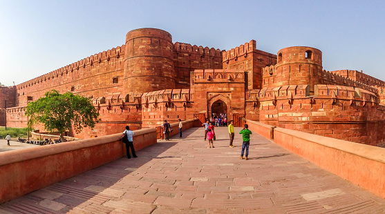 Agra, India - 26 April, 2015: Tourists are taking pictures of each other in front of the fort.