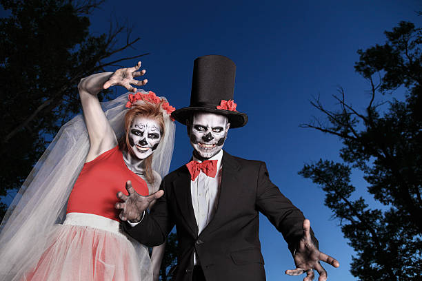 istock spooky zombie  bride and groom at dusk 498998541
