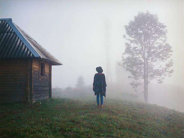Woman in the foggy field 