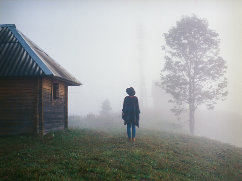 Woman in the foggy field 