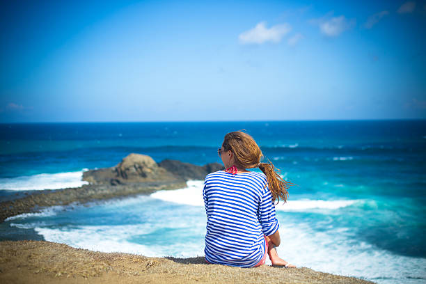 istock girl sitting on a mountain 499001123