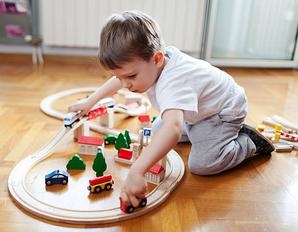 Trains are boys best friends Little boy playing with wooden train set miniature train stock pictures, royalty-free photos & images