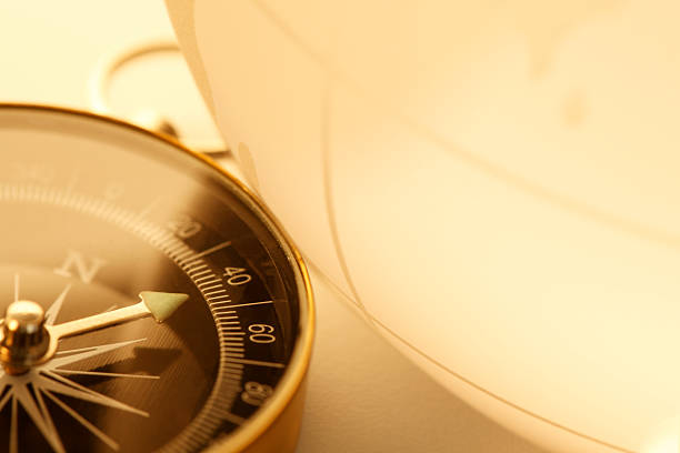 istock Compass sitting at the base of crystal globe 499002207