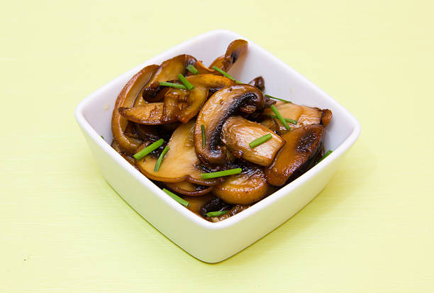 istock Baked mushrooms on square bowl on green 499005688