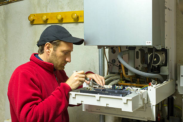 istock plumber repairing a condensing boiler 499018352