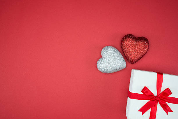 istock gift box wrap silk ribbon with two love heart shape 499018788