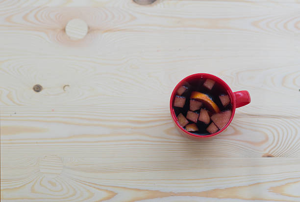 istock Cup of mulled red wine on wooden table for Christmas 499019890