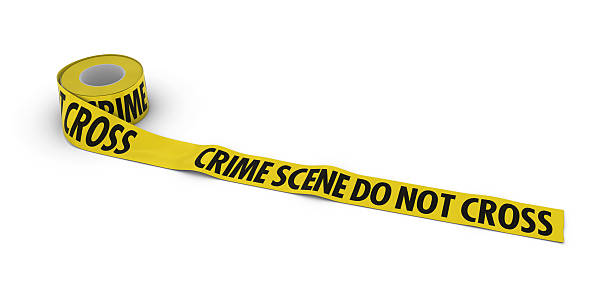 istock Crime Scene Do Not Cross Tape Roll unrolled across floor 499021866