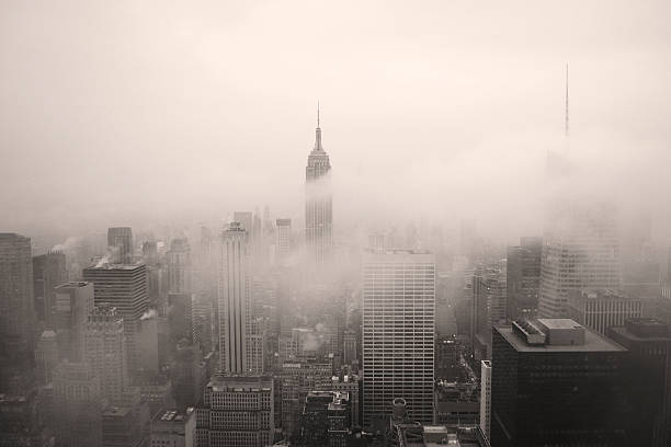 New York City Panorama in Black and White in Fog New York City, NY, United States of America. New York City in the fog. December 2014.  empire state building photos stock pictures, royalty-free photos & images