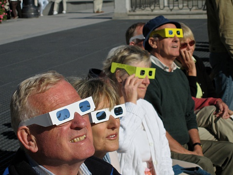 Madrid, Spain – October 3th, 2005: People watching with special glasses a solar eclipse in Madrid. 
