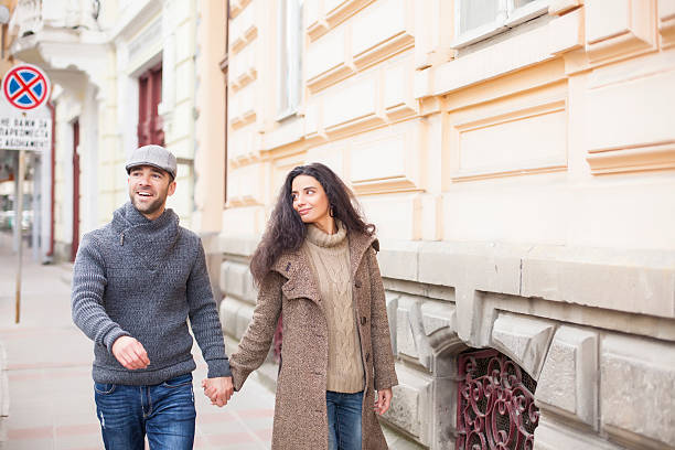 istock Young couple against cityscape background 499025646