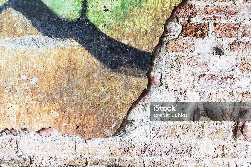 Dirty concrete wall with graffiti and big crack Dirty concrete wall with graffiti and big crack showing brickwall Aging Process Stock Photo