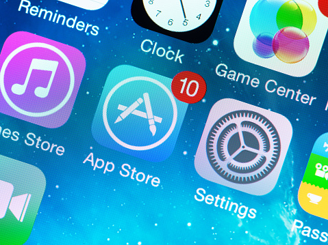 Kiev, Ukraine - June 12, 2014: A close-up photo of Apple iPhone 5s start screen with application icons, includes App Store, Settings, Clock, Game Center and others. App Store is a digital distribution service for mobile apps on iOS platform, developed by Apple Inc.