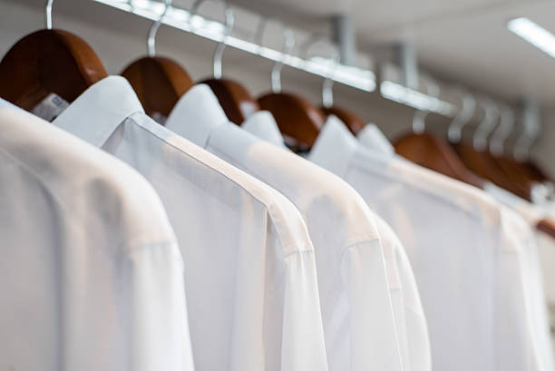istock row of white shirts hanged in closet (soft focus) 499029950