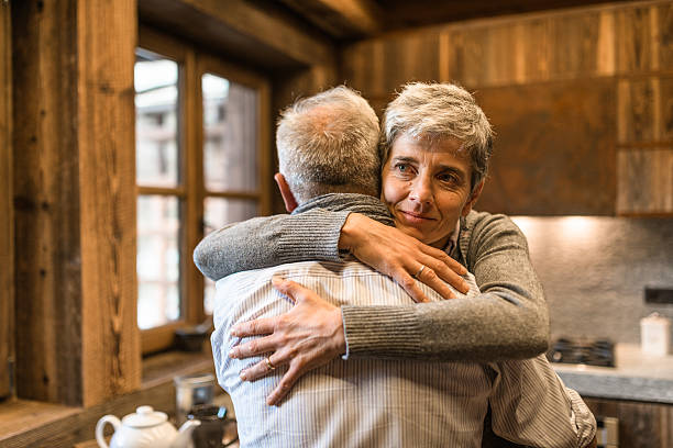 istock senior couple embracing passionate in the house - support concept 499030678