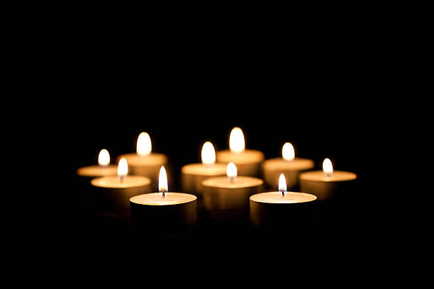 Burning candles  Burning candles on a black background memorial vigil stock pictures, royalty-free photos & images