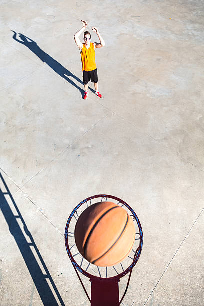 istock Basketball player throwing ball into hoop 499031602