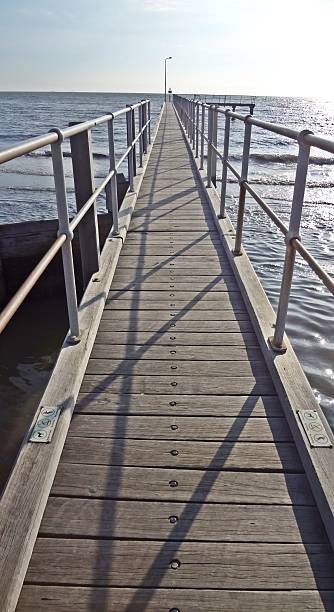 Wooden bridge over the sea stock photo