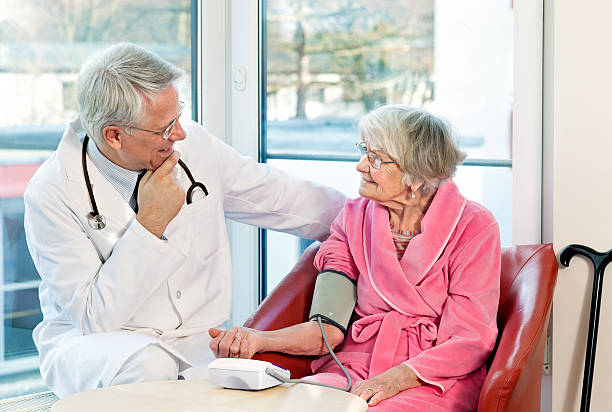 istock Doctor taking an elderly womans blood pressure. 499033741