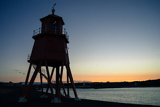 istock Herd Groyne Lighthouse at sunset 499047316