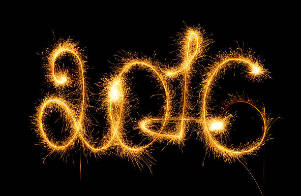 istock Happy New Year - 2016 with sparklers on black 499048366