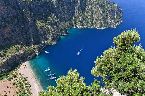 Blue voyage / Butterfly Valley The Butterfly Valey in the city of Oludeniz/Fethiye in western Turkey. You can only reach this valey by boat.The Butterfly Valey in the city of Oludeniz/Fethiye in western Turkey. You can only reach this valey by boat. sunning butterfly stock pictures, royalty-free photos & images