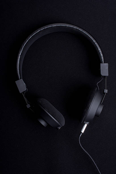 istock black headphones on black fabric 499051052