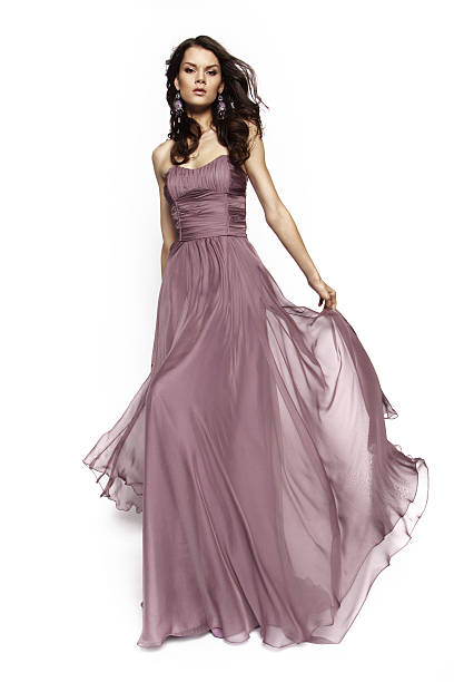 istock Brunette model in violet dress posing 499053432
