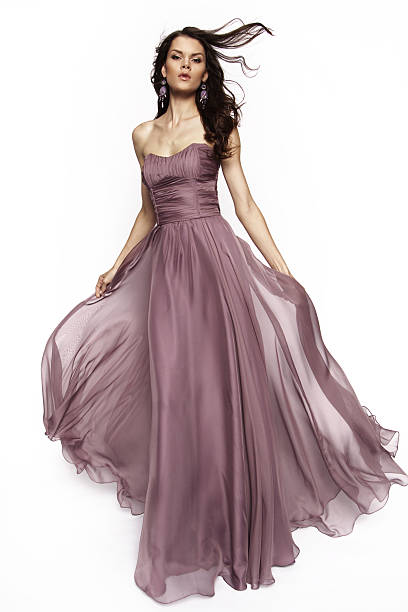 istock Brunette model in violet dress posing 499053550