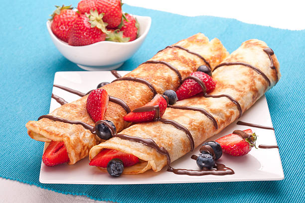 istock Pancakes served with strawberries, blueberries and chocolate on 499053844