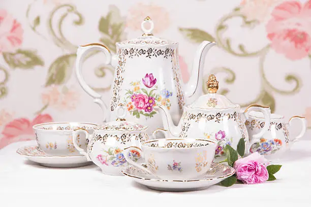 Antique floral tea set on a white tablecloth