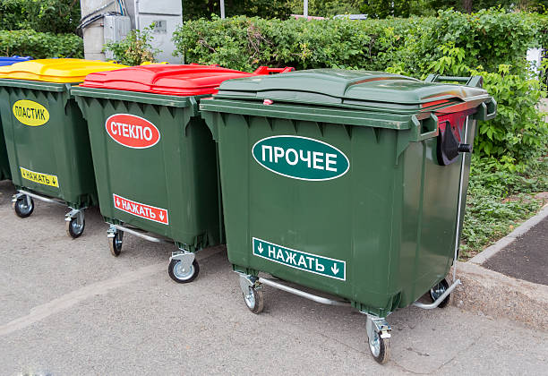 istock Green dumpsters on a city street 499057303