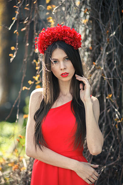 istock Young pretty girl is posing with flowers 499057453
