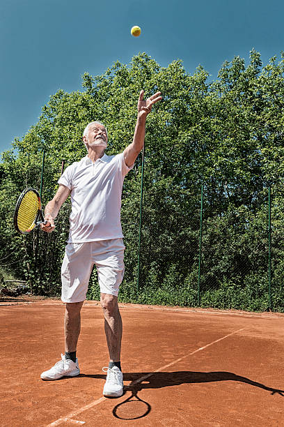 istock Senior tennis player serving 499058035