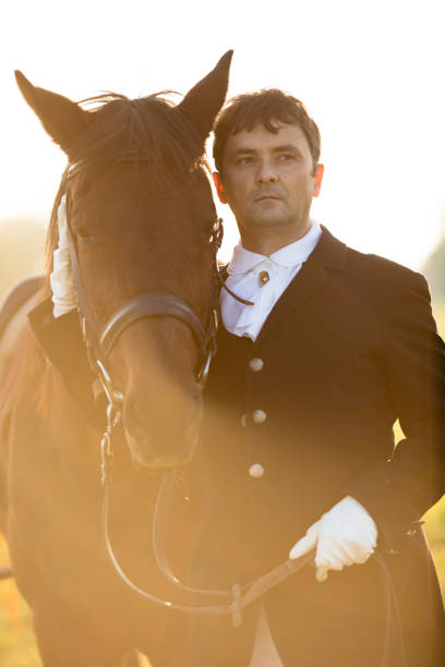 istock Man standing with horse on meadow 499058434