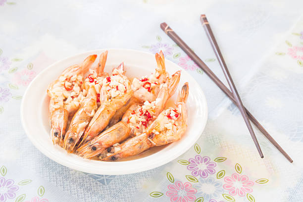cooked prawn with the chopped chili and garlic on top
