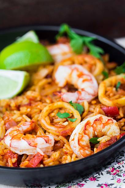 istock Spanish dish paella with seafood, shrimps, squid, rice, saffron 499060033