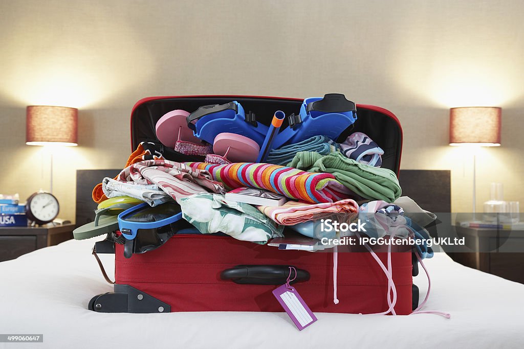 Open suitcase on bed Suitcase Stock Photo