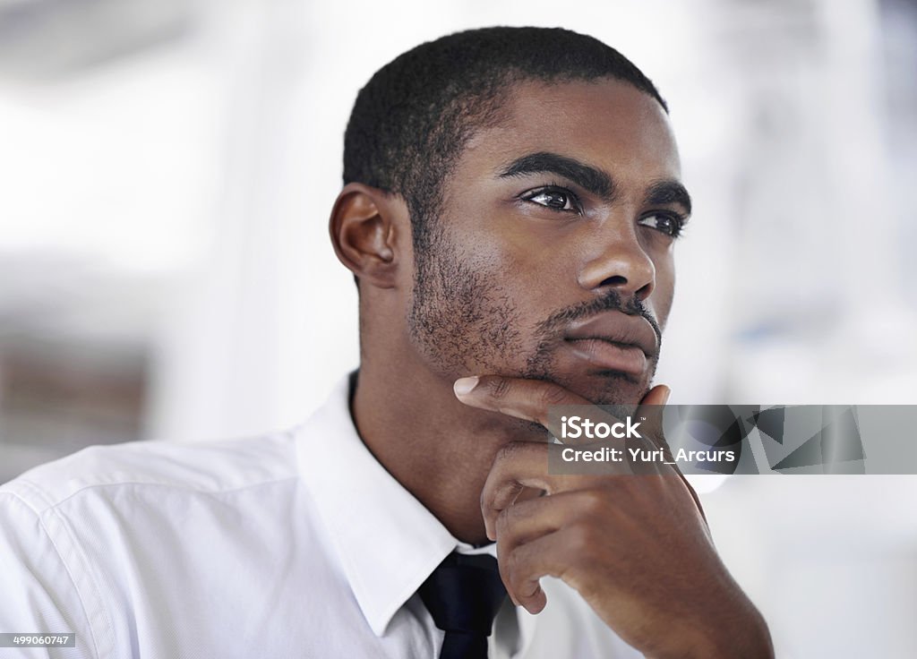 Mulling over success Close up shot of a handsome african businessman looking contemplative African Ethnicity Stock Photo