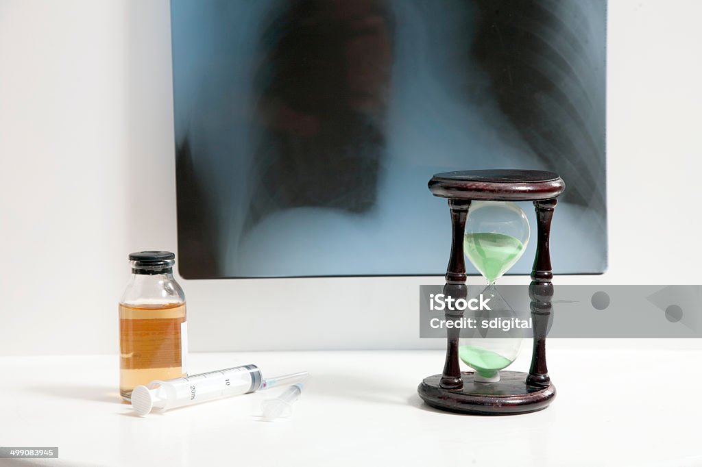 Roentgen, hourglass and medicine roentgen, hourglass and syringes with medicine on white table Accessibility Stock Photo