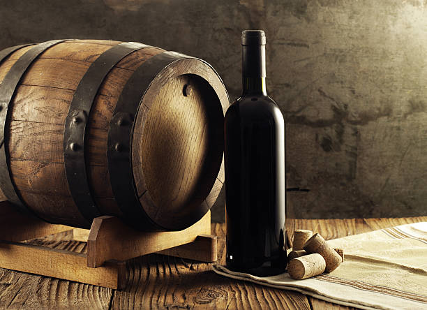 istock Red wine bottle and old barrel 499084743