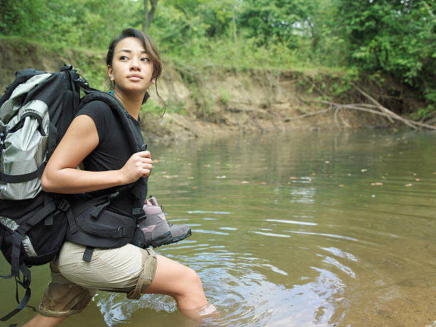 istock Woman With Backpack Walking In Forest Water 499085691