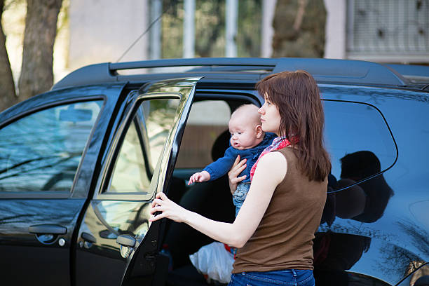 istock Young mother with her baby getting into a car 499086081