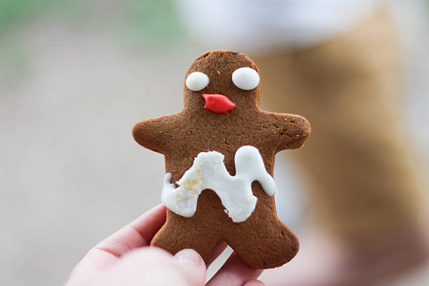 Funny looking gingerbread man with smudged icing stock photo