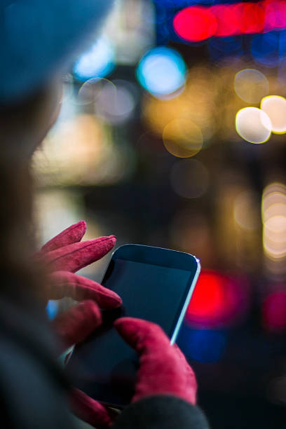 istock Human hands using smartphone in city at night time 499088028