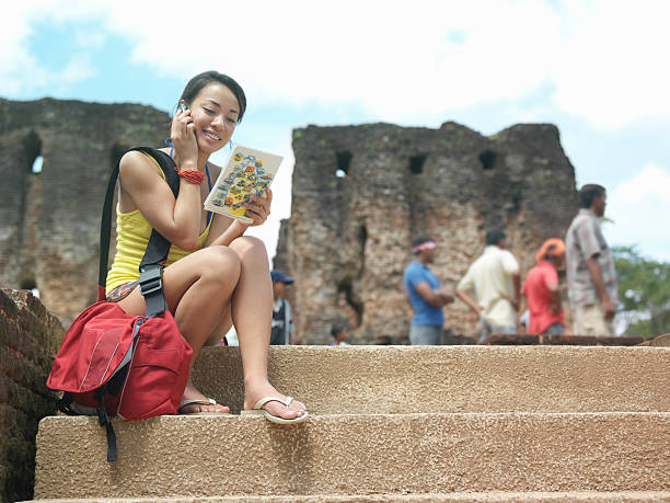 istock Woman With Cellphone And Guidebook Against Old Ruins 499092391